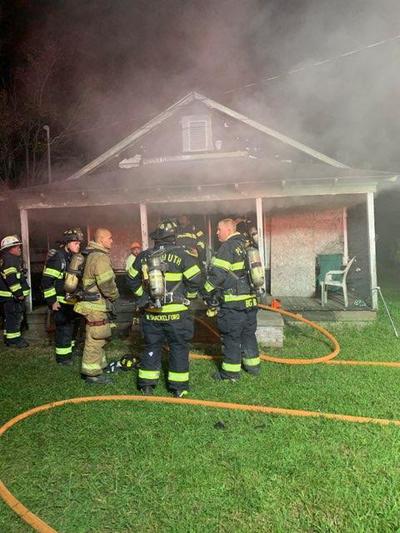 Firefighters fighting a residential fire