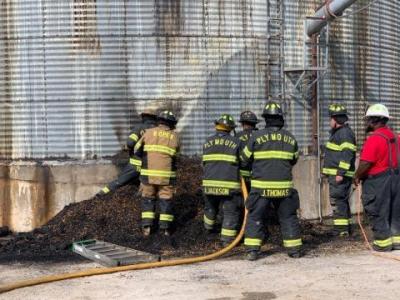 Firefighters putting out fire at grain silo